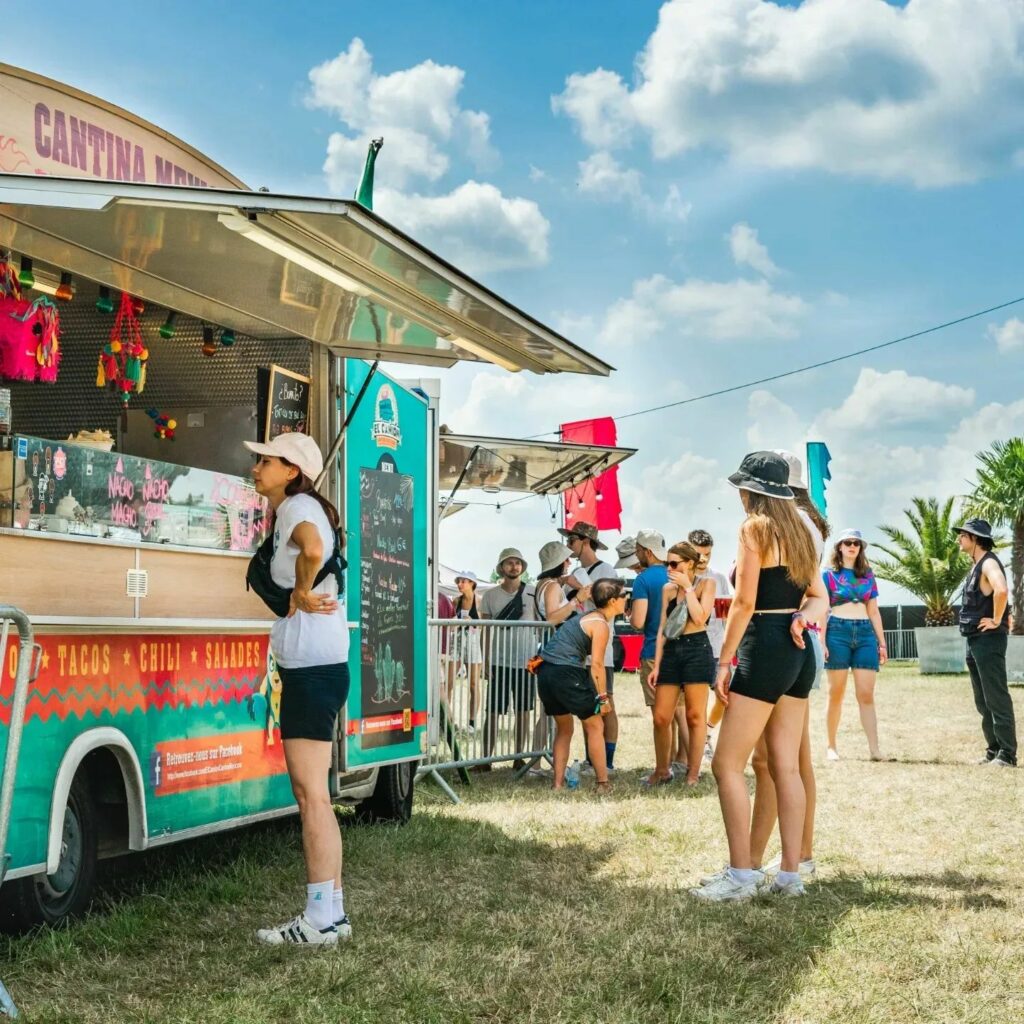 Les gens font la queue pour un camion de nourriture par une journée ensoleillée